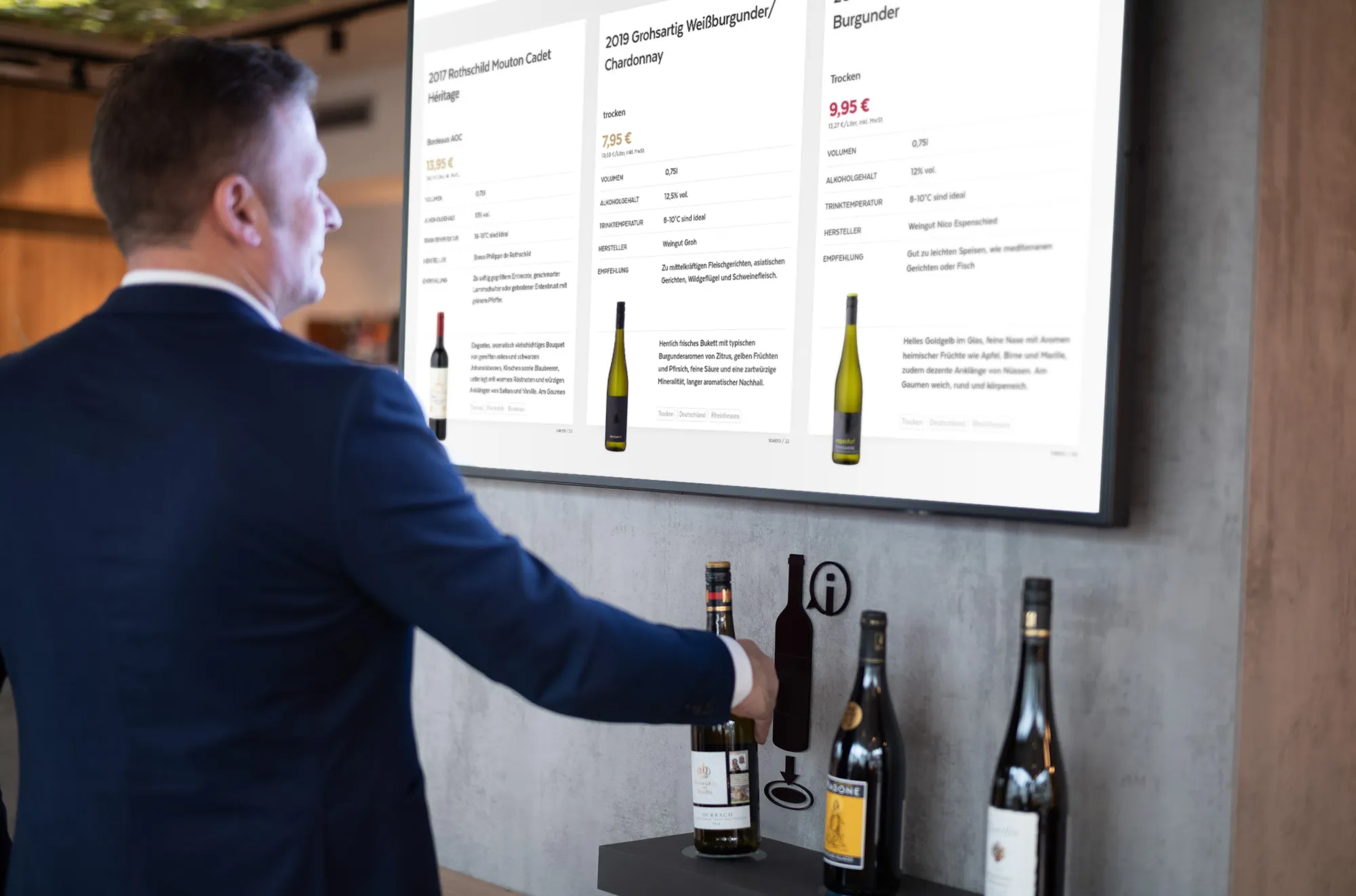 Kunde informiert sich an einem interaktiven Weinregal mit Bildschirm bei Ludwig von Kapff